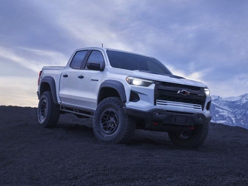 2024 Chevrolet Colorado ZR2 Bison parked on a mountain at night with headlights on