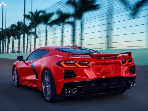 2024 Chevrolet Corvette Stingray rear exterior view of car driving fast on a raceway