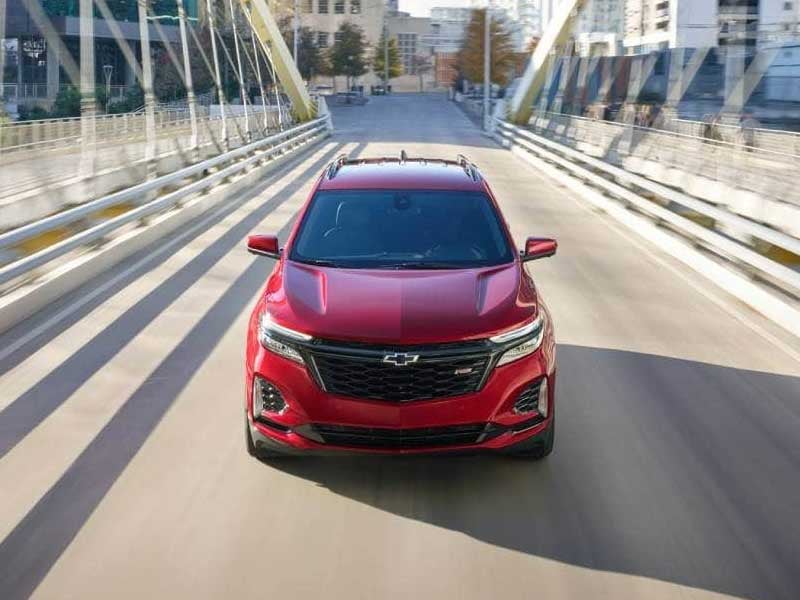 Front view of Chevrolet Equinox driving on bridge with motion blur